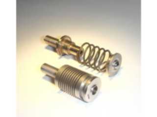 Machined spring assimilates separate parts.